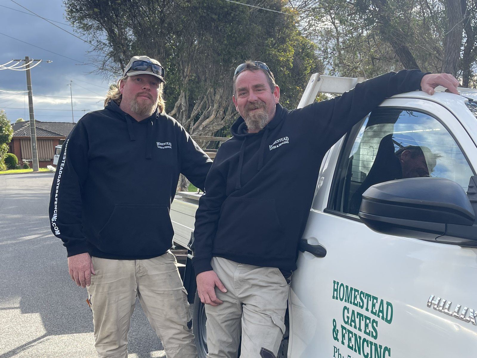 Dave and Andrew standing beside the Homestead Gates and Fencing ute in Geelong
