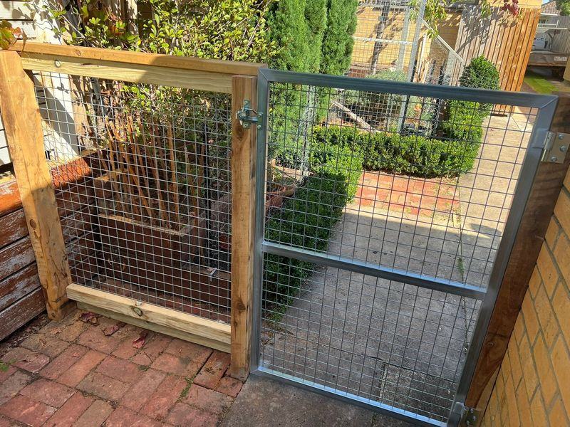 Galvanised weldmesh panels enclosing a back garden