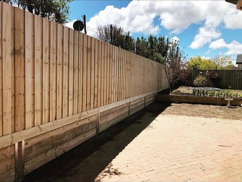 Paling fence built over a sleeper retaining base