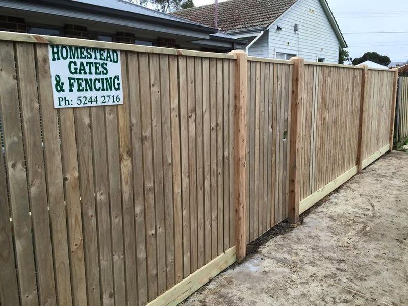 Exposed post paling fence along a driveway