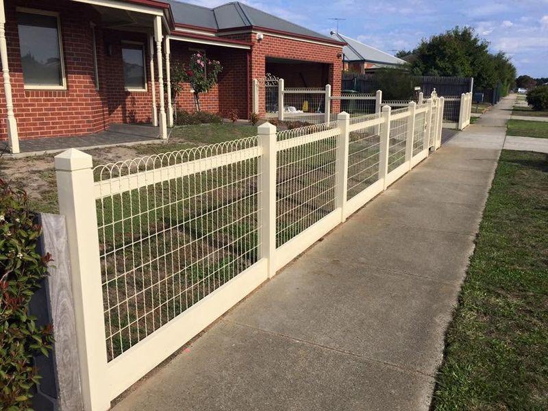 Woven wire front fence with matching gates on a brick home